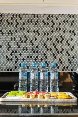 a group of bottles of water on a tray with food at Morden 2BR With Full sea view -High floor in Dubai