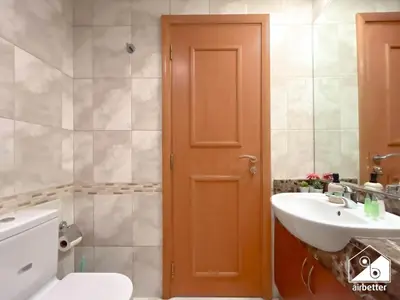 a bathroom with a toilet and a sink at 1BR City Escape at Marina Residence Pool & Gym in Dubai