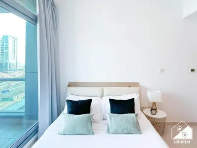 a bedroom with a bed with a large window at 1BR City Escape at Marina Residence Pool & Gym in Dubai