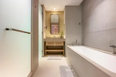 a bathroom with a tub and a sink and a mirror at Vida Dubai Mall - Luxury 1BR with Direct access to Dubai Mall in Dubai