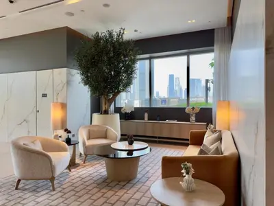 a lobby with couches and chairs and a large window at Vida Dubai Mall - Luxury 1BR with Direct access to Dubai Mall in Dubai