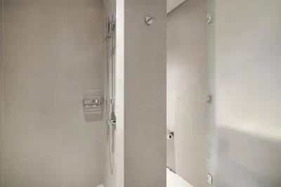 a bathroom with a shower and a toilet in it at Vida Dubai Mall - Luxury 1BR with Direct access to Dubai Mall in Dubai