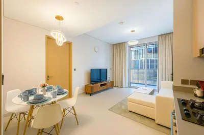 a living room with a table and a couch at Vida Dubai Mall - Luxury 1BR with Direct access to Dubai Mall in Dubai