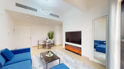 a living room with a blue couch and a tv at Locations l Elegant 1 Bedroom l Skyline Views l Dubai Marina in Dubai