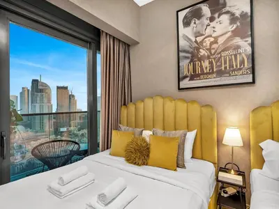 a bedroom with a bed with a large window at Fountain view Golden Era Cinema-Inspired 4BR APT in Dubai