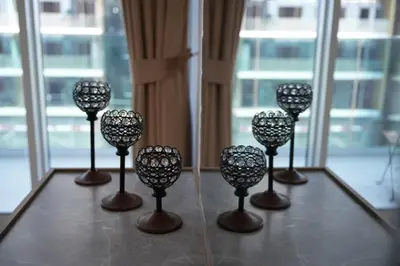 a group of wine glasses sitting on a table at Skyline 19 1 Residences in Dubai