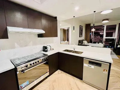a kitchen with a sink and a stove top oven at Skyline 19 1 Residences in Dubai