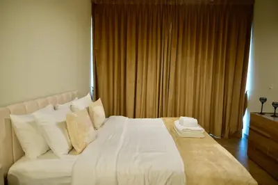 a bedroom with a large bed with white sheets and pillows at Skyline 19 1 Residences in Dubai