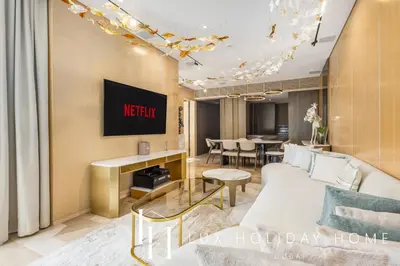 a living room with a white couch and a table at LUX The Five Palm Jumeirah Suite in Dubai