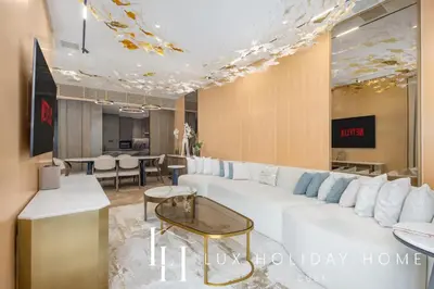 a living room with a white couch and a table at LUX The Five Palm Jumeirah Suite in Dubai