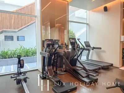a gym with treadmills and ellipticals in a building at LUX The Five Palm Jumeirah Suite in Dubai