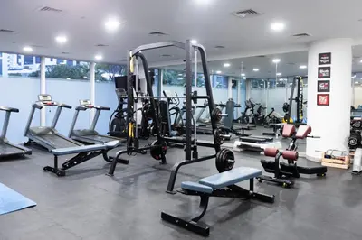 a gym with a lot of treadmills and machines at Stylish 2BR Oasis in Business Bay with Pool & Gym in Dubai