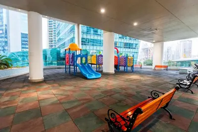 a room with a playground with tables and chairs at Stylish 2BR Oasis in Business Bay with Pool & Gym in Dubai