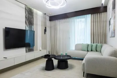 a living room with a couch and a flat screen tv at Stylish 2BR Oasis in Business Bay with Pool & Gym in Dubai