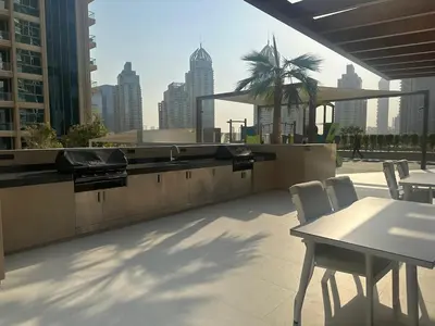 a patio with a table and chairs and a city skyline at Luxury 1Bed at LIV Marina Stunning Marina Views in Dubai