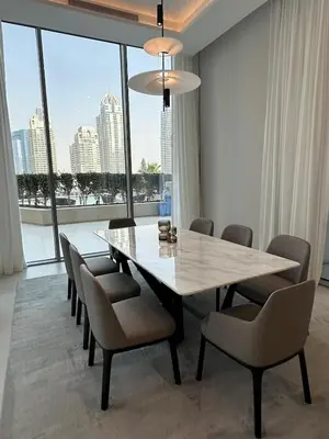 a dining room with a table and chairs and a large window at Luxury 1Bed at LIV Marina Stunning Marina Views in Dubai