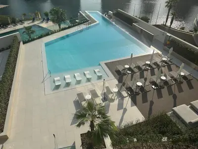 an overhead view of a large swimming pool with chairs at Luxury 1Bed at LIV Marina Stunning Marina Views in Dubai