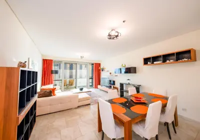 a living room with a table and a couch at JBR High Floor 2BR Stunning Ain Dubai View in Dubai