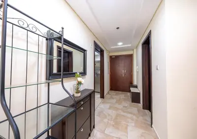 a hallway with a glass staircase in a house at JBR High Floor 2BR Stunning Ain Dubai View in Dubai