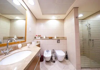 a bathroom with two toilets and a sink and a shower at JBR High Floor 2BR Stunning Ain Dubai View in Dubai