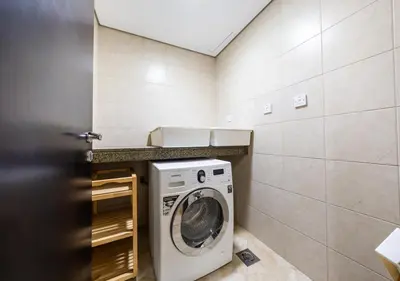 a laundry room with a washing machine in a room at JBR High Floor 2BR Stunning Ain Dubai View in Dubai