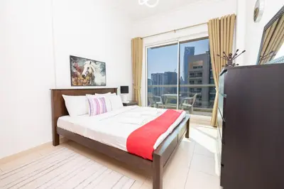 a bedroom with a bed and a large window at Modern 1BR -Canal Views & Burj Views -Business Bay in Dubai