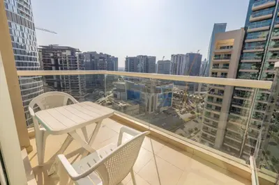 a balcony with a table and chairs on a building at Modern 1BR -Canal Views & Burj Views -Business Bay in Dubai