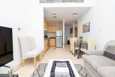 a living room with a couch and a table at Modern 1BR -Canal Views & Burj Views -Business Bay in Dubai