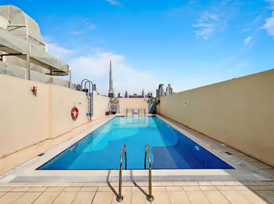a pool on the roof of a building with a view of the city at Modern 1BR -Canal Views & Burj Views -Business Bay in Dubai
