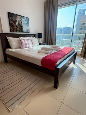 a large bed in a room with a large window at Modern 1BR -Canal Views & Burj Views -Business Bay in Dubai