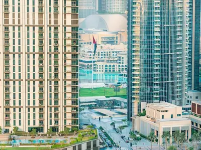 an aerial view of a city with tall buildings at 2BR With Rooftop Pool Offering Burj Khalifa Views in Dubai