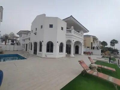 a large white house with a swimming pool at BLVD Beach House in Dubai