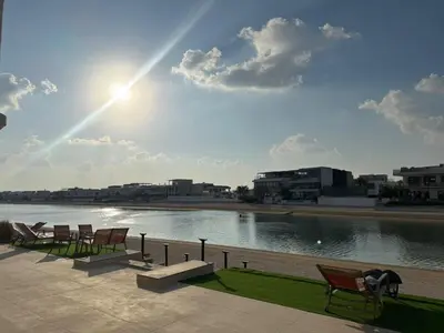 a group of chairs sitting next to a body of water at BLVD Beach House in Dubai