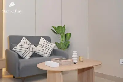 a living room with a couch and a coffee table at MarvelStay - Beach 5 mins - Fits 3 - Pool-Gym-Sauna - Marina in Dubai