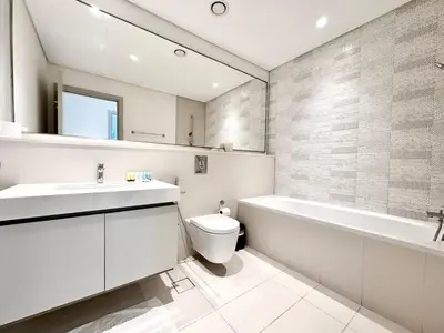 a bathroom with a sink and a toilet and a bath tub at Direct Beach Access 2BHK in Dubai