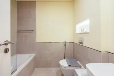 a bathroom with a toilet and a tub and a sink at Exclusive 2BR in Rahaal 2, Madinat Jumeirah Living in Dubai