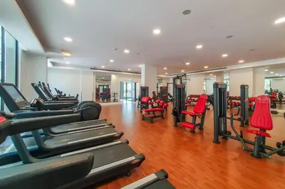 a gym with rows of treadmills and exercise machines at Exclusive 2BR in Rahaal 2, Madinat Jumeirah Living in Dubai