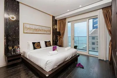 a bedroom with a large bed and a large window at Lavish 2-Bedroom Apartment in Dubai Oasis in Dubai