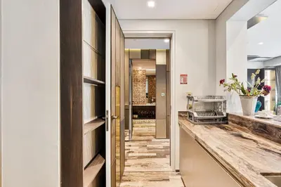 a hallway with a door leading into a bathroom at Lavish 2-Bedroom Apartment in Dubai Oasis in Dubai