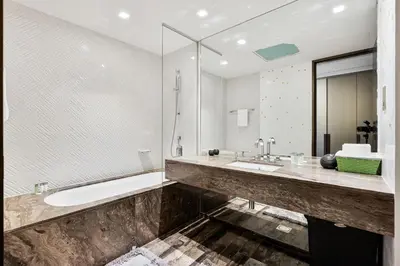 a large bathroom with a tub and a sink at Lavish 2-Bedroom Apartment in Dubai Oasis in Dubai