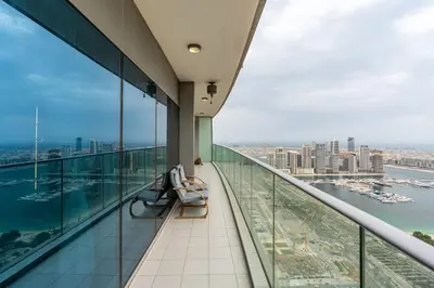 a balcony with chairs and a view of the city at Lavish 2-Bedroom Apartment in Dubai Oasis in Dubai