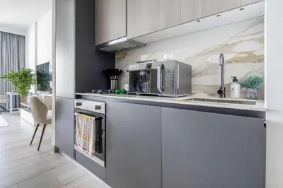 a kitchen with a sink and a microwave at Frank Porter - Grove by Eman in Dubai