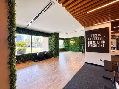 a large room with plants on the walls at Elite Studio with Burj Khalifa & Pool View in Dubai