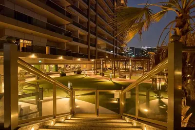 an external view of a building at night at Elite Studio with Burj Khalifa & Pool View in Dubai