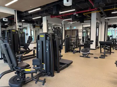 a gym with a lot of treadmills and machines at Stylish Studio with Burj Khalifa Views in Dubai