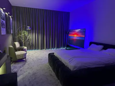 a bedroom with a large bed and a purple room at Stylish Studio with Burj Khalifa Views in Dubai
