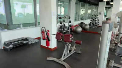 a gym with cardio equipment in a building at Beachside Palm Jumeirah 1 Br apartment in Dubai