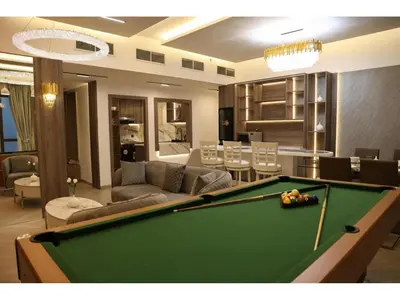 a living room with a pool table in a room at The bahar bloom stay in Dubai