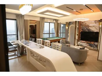 a living room with a table and a pool table at The bahar bloom stay in Dubai