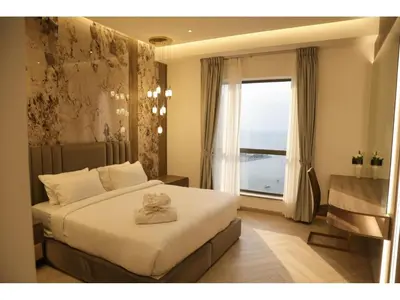a bedroom with a large bed and a window at The bahar bloom stay in Dubai